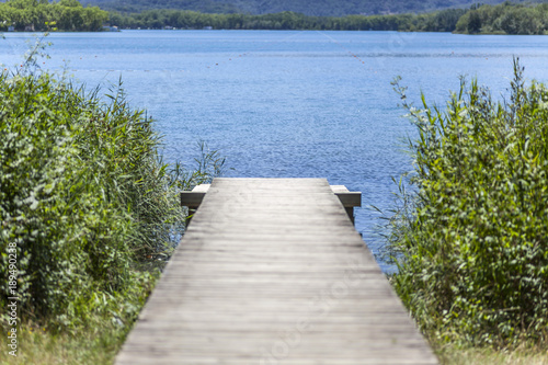 Lake view with wooden walkway in Banyoles Catalonia Spain.