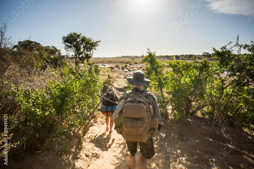 Trackers in South Africa. Game Rangers in South Africa walking through the bush with rifles.