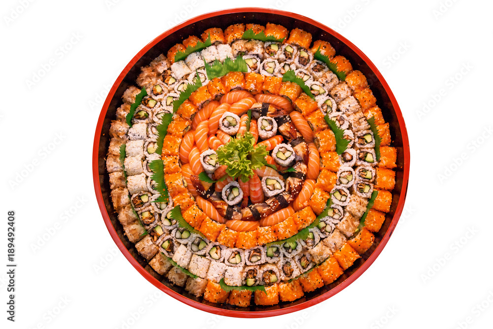 different types of sushi are stacked on a round dish on a white background. A variety of Japanese sushi buns.