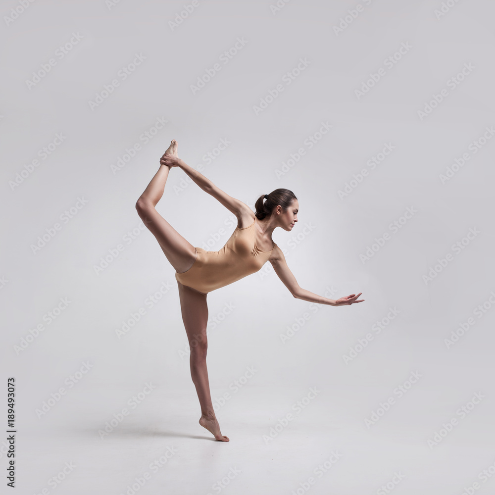 Fototapeta premium young beautiful dancer in beige swimsuit