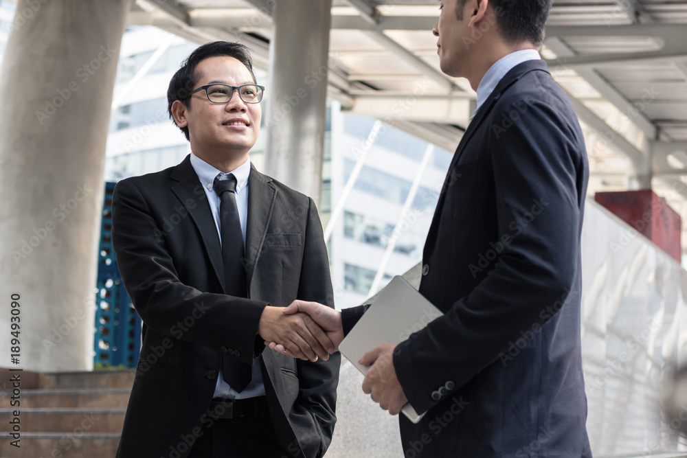 cooperation and success concept, team of business people shaking hand with boss or leader outside for greeting and deal successful business project. cooperation and success concept, team of business people shaking hand with boss or leader outside for greeting and deal successful business project.
