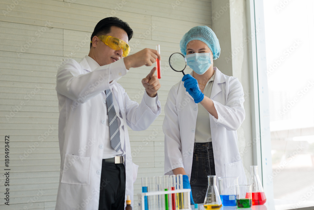 Two scientists are conducting experiments in vitro in the laboratory.. Two scientists are conducting experiments in vitro in the laboratory..