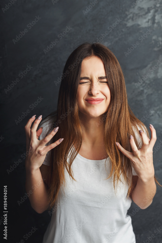 Emotional stressed woman portrait on dark background Emotional stressed woman portrait on dark background