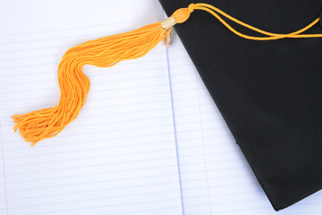 mortar board tassel notebook paper graduation concept