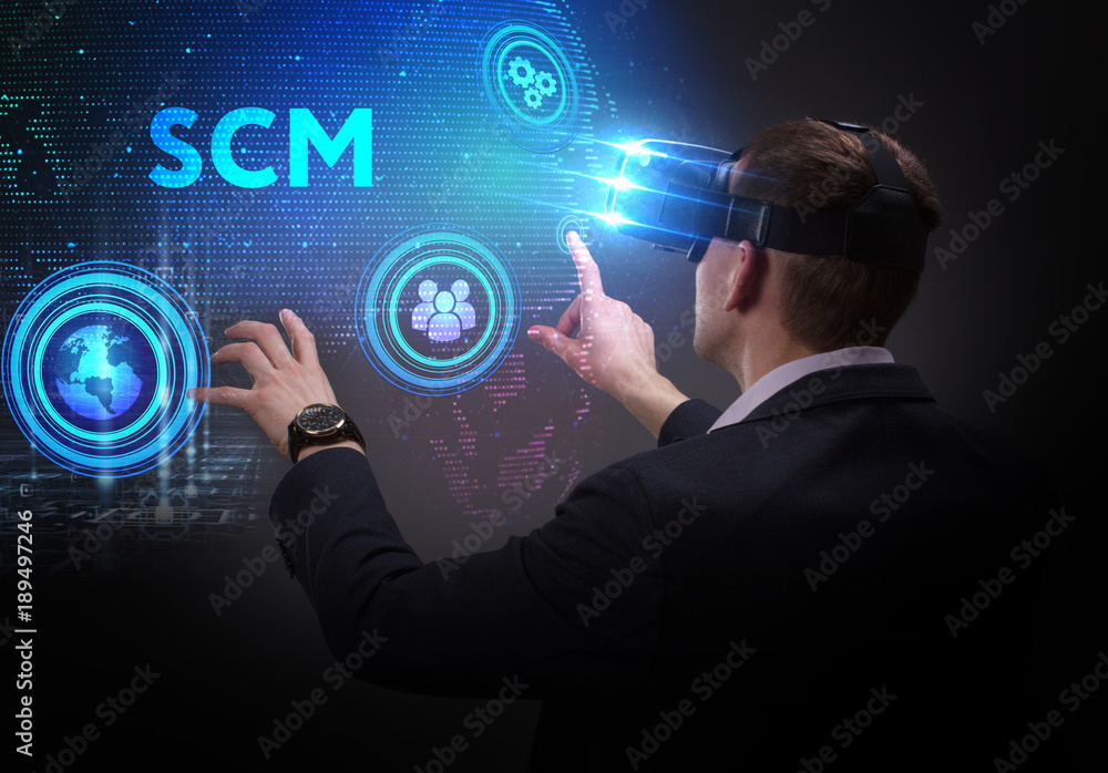 Business, Technology, Internet and network concept. Young businessman working on a virtual screen of the future and sees the inscription: SCM Business, Technology, Internet and network concept. Young businessman working on a virtual screen of the future and sees the inscription: SCM