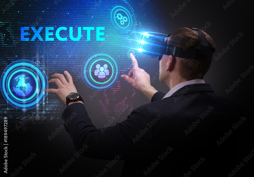 Business, Technology, Internet and network concept. Young businessman working on a virtual screen of the future and sees the inscription: Execute Business, Technology, Internet and network concept. Young businessman working on a virtual screen of the future and sees the inscription: Execute