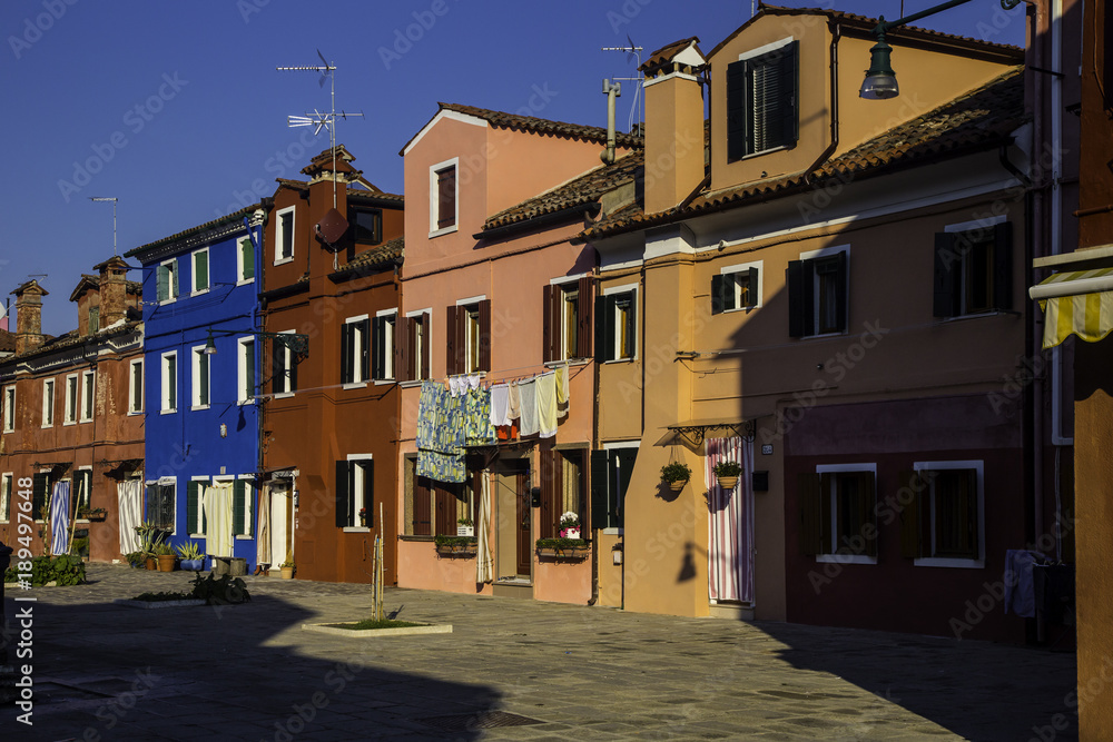 Burano, Venice. Colorful houses architecture, Burano island canal and boats, Italy