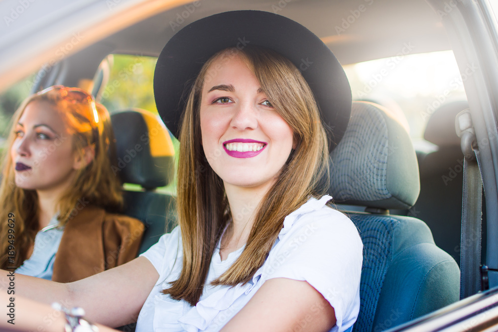 Two girl friends on a road trip by car Two girl friends on a road trip by car