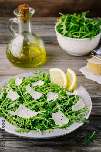 Green arugula salad with Parmesan cheese, lemon, olive oil and seasonings