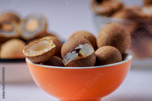 Longan fruit; in a plate; on; white; background.