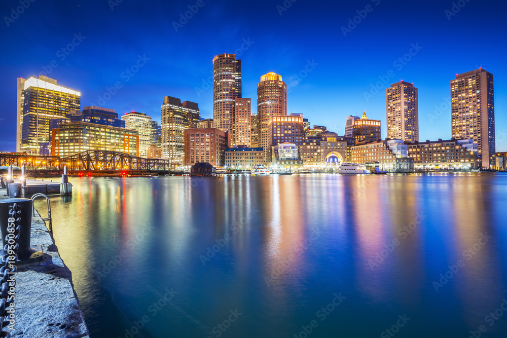 The Boston skyline at night, located in Fan Pier Park, Boston, Massachusetts, USA.