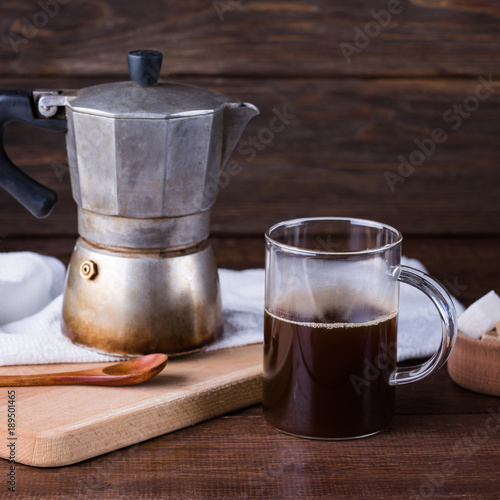 old coffee pot, geyser, glass mug with coffee, wooden background