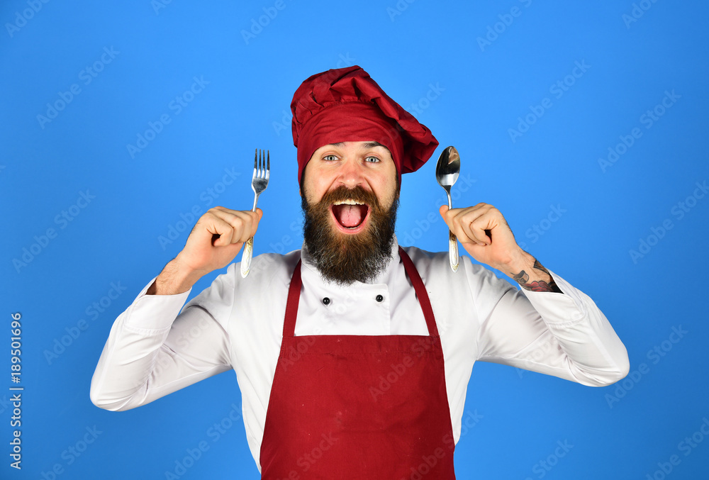 Cooking process commercial concept. Chef holds cutlery. Cooking process commercial concept. Chef holds cutlery.