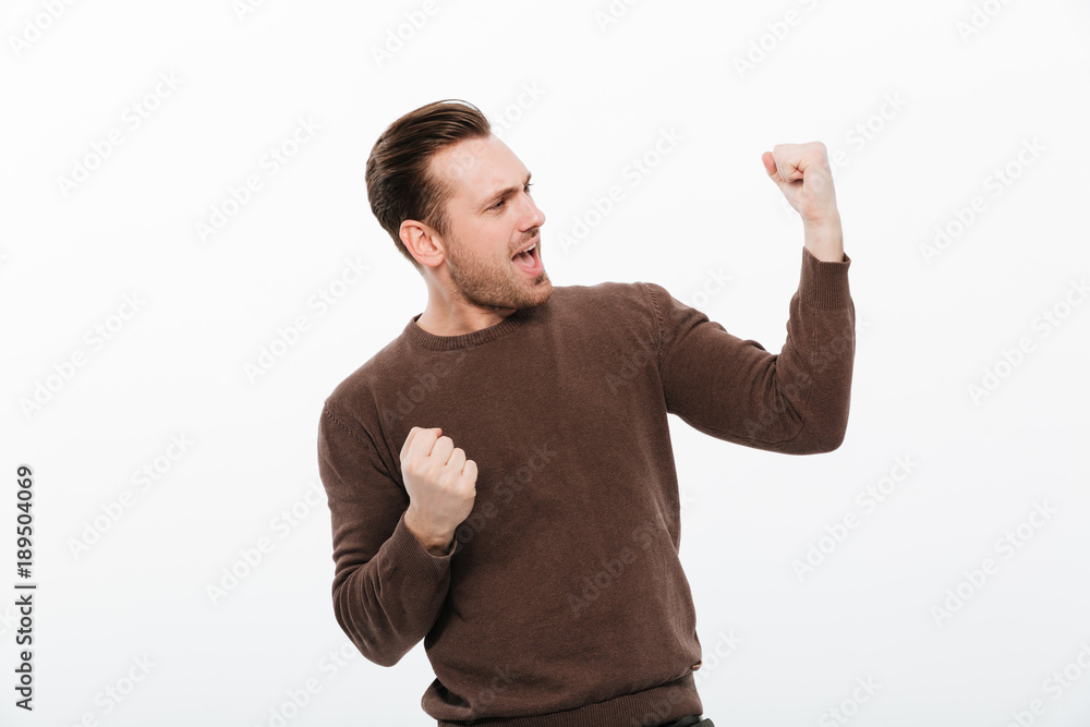 Excited young man make winner gesture. Excited young man make winner gesture.