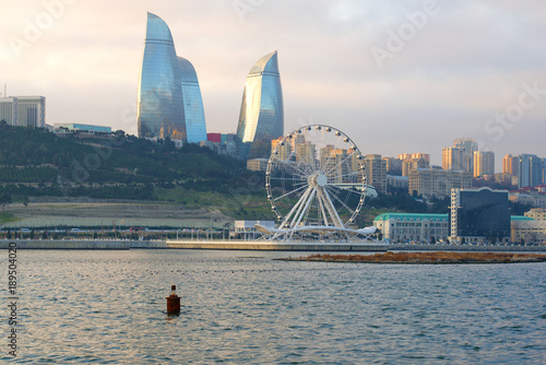 View of the Ferris wheel and the Flame Towers on a December cloudy day. Baku