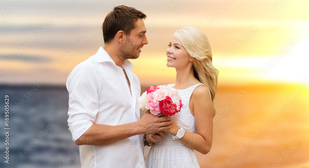 happy couple with flowers over sea background happy couple with flowers over sea background