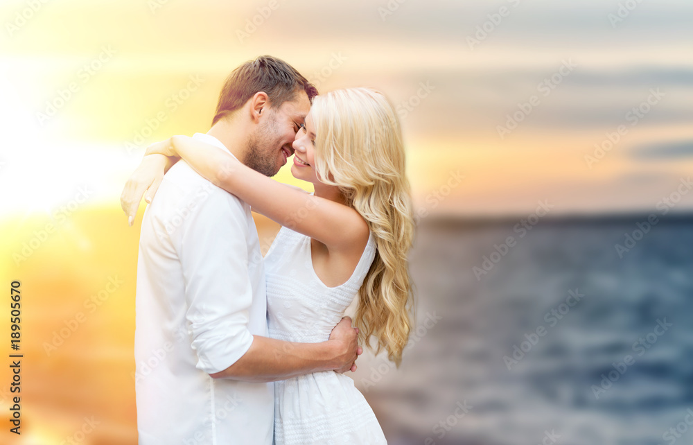 happy couple hugging and kissing on summer beach happy couple hugging and kissing on summer beach