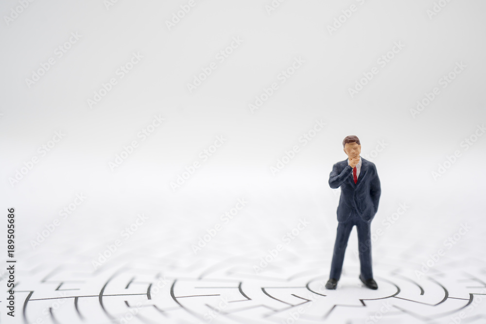 Miniature toy:Business man thinking how to solve this problem.Business obstacle,financial,business growth concept. Miniature toy:Business man thinking how to solve this problem.Business obstacle,financial,business growth concept.