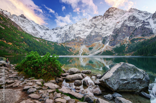 Landscape with mountain and calm water.