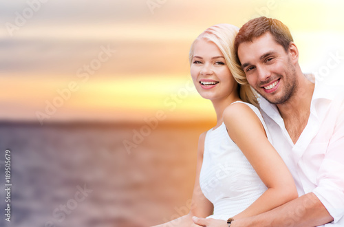 happy couple hugging over sea background