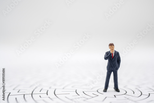 Miniature toy:Business man thinking how to solve this problem.Business obstacle,financial,business growth concept.