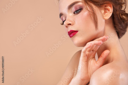 Closeup portrait of beautiful young woman with clean and fresh skin. Nude makeup. Model looking on copyspace. Concept for cosmetology ads  beauty magazine and spa.