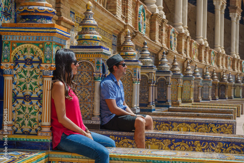 handsome happy couple take photo in Spain Square (Plaza de Espana), Seville, Spain, during a world trip tour