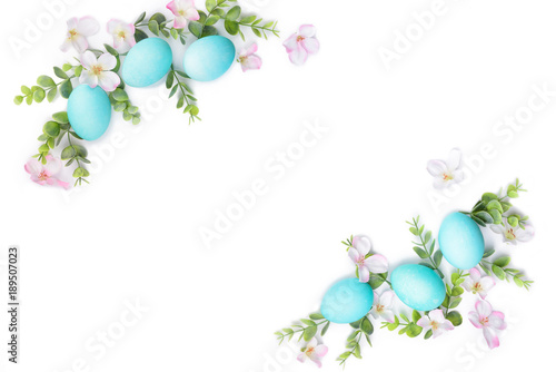 Spring Easter border composition. Turquoise eggs and green plant isoleted on white background. Blooming flowers. Copy space for text
