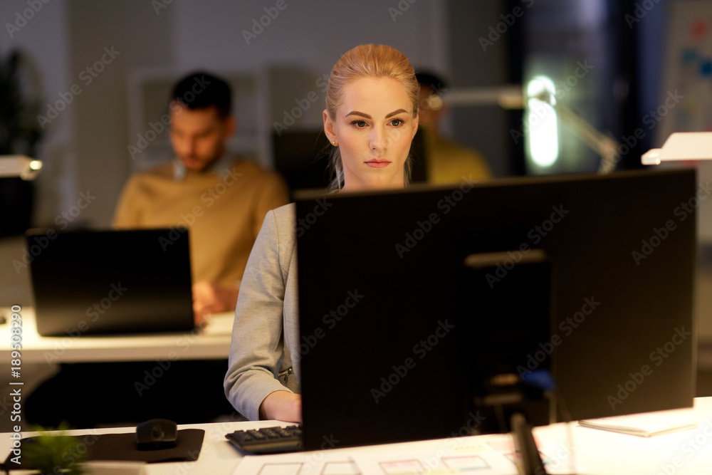 businesswoman at computer working at night office businesswoman at computer working at night office