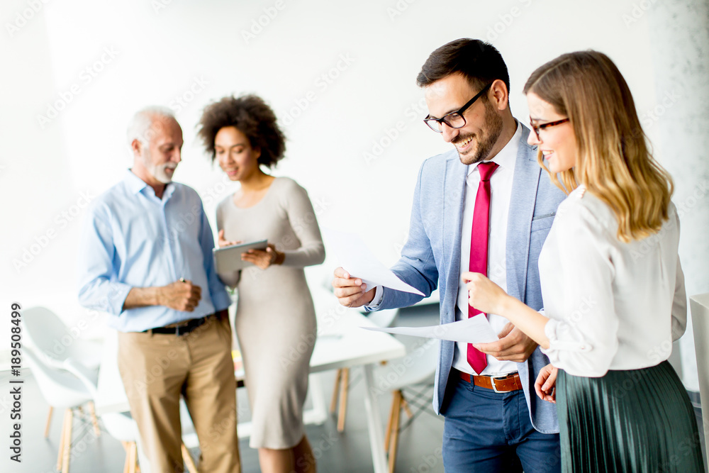 Multiracial business people standing in the office Multiracial business people standing in the office