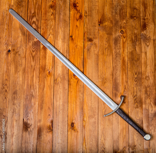 knightly sword on a wood table photo