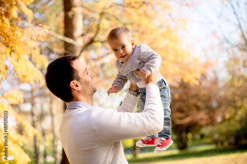 Young father and baby boy in autumn park