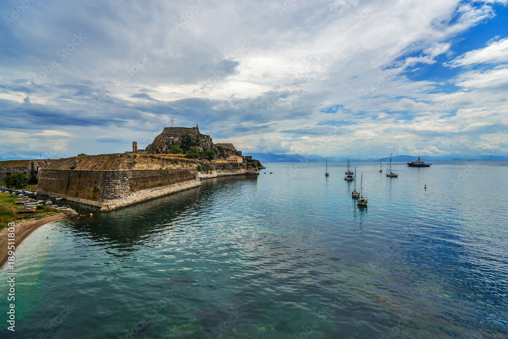 Old fortress in Corfu and boats on Ionian sea. Greece.
