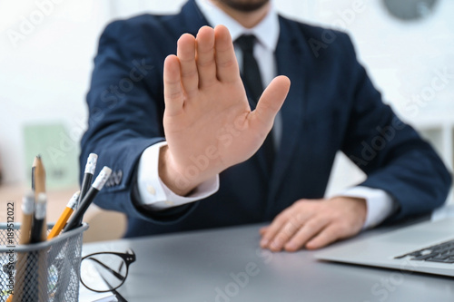 Businessman refusing to take bribe indoors, closeup