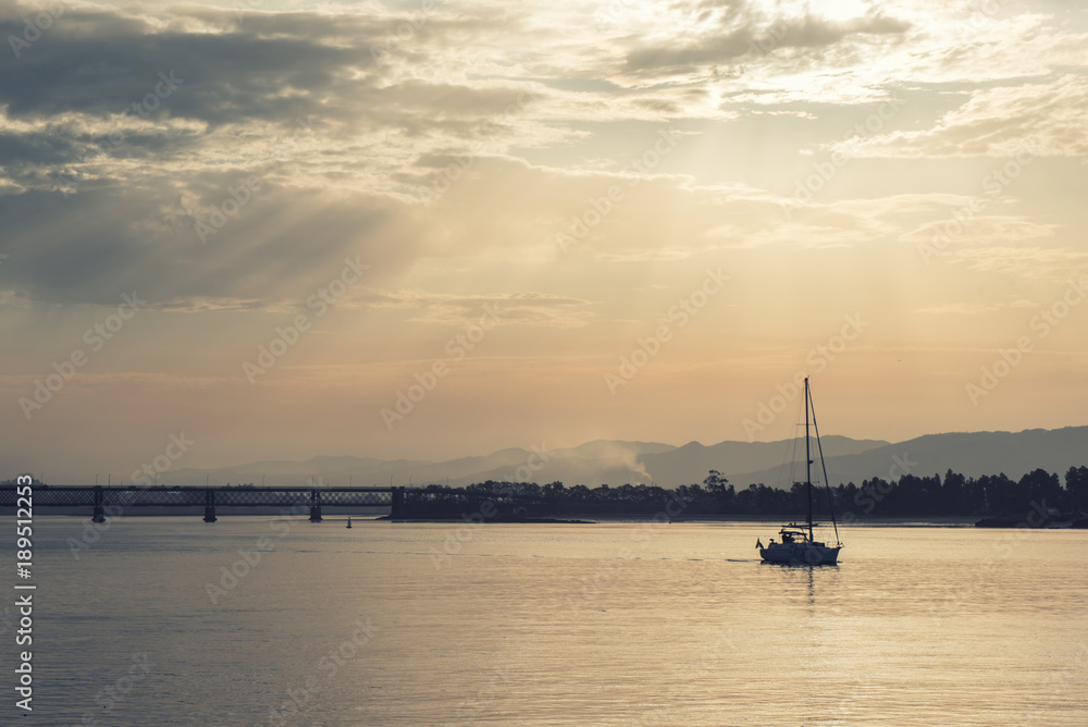 Boat sailing at dawn along the Lima river