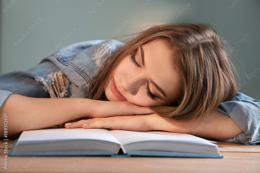 Tired student sleeping at her desk. Preparing for exam Tired student sleeping at her desk. Preparing for exam