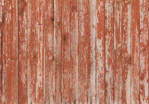 Background of old wooden board with cracked red paint