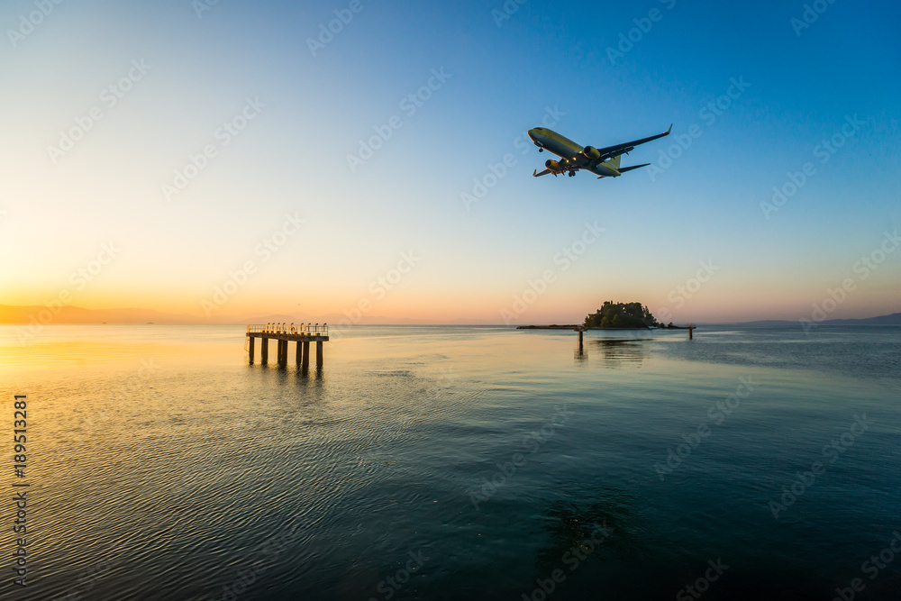 Modern civilian airplane landing at early morning. Flew above airport approach landing light on the Ionian sea at Corfu international airport, Greece. Modern civilian airplane landing at early morning. Flew above airport approach landing light on the Ionian sea at Corfu international airport, Greece.