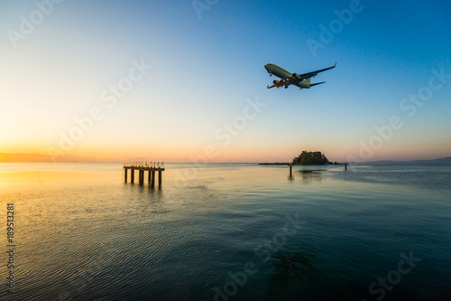 Modern civilian airplane landing at early morning. Flew above airport approach landing light on the Ionian sea at Corfu international airport, Greece.