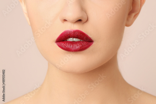 Woman with beautiful makeup on light background. Professional visage artist work
