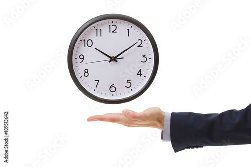 Businessman hand holding wall clock, time management