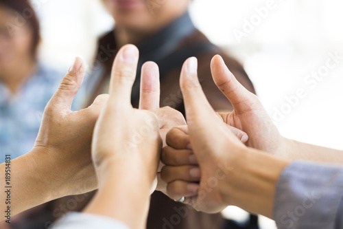 Business people thumb up , team success symbol. Soft focused with beautiful blurred background.