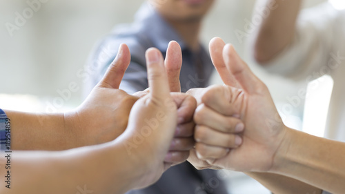 Business people thumb up , team success symbol. Soft focused with beautiful blurred background.