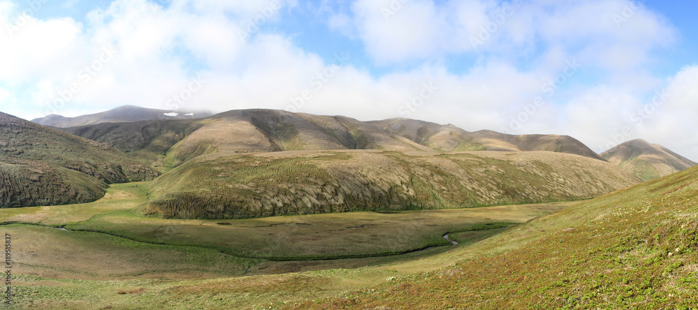 Panorama of hillock and the valley of the river on the island of Copper in a summer sunny day Panorama of hillock and the valley of the river on the island of Copper in a summer sunny day