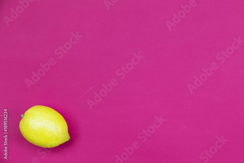 Top view of colorful fruit pattern of fresh lemon on pink background