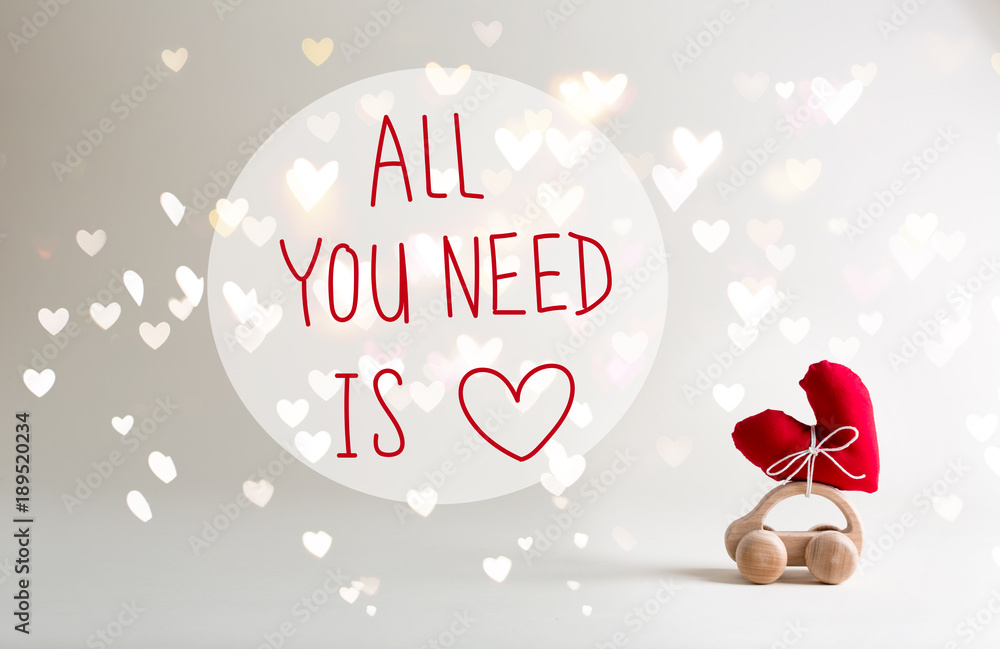 All You Need Is Love message with toy car carrying a heart cushion
