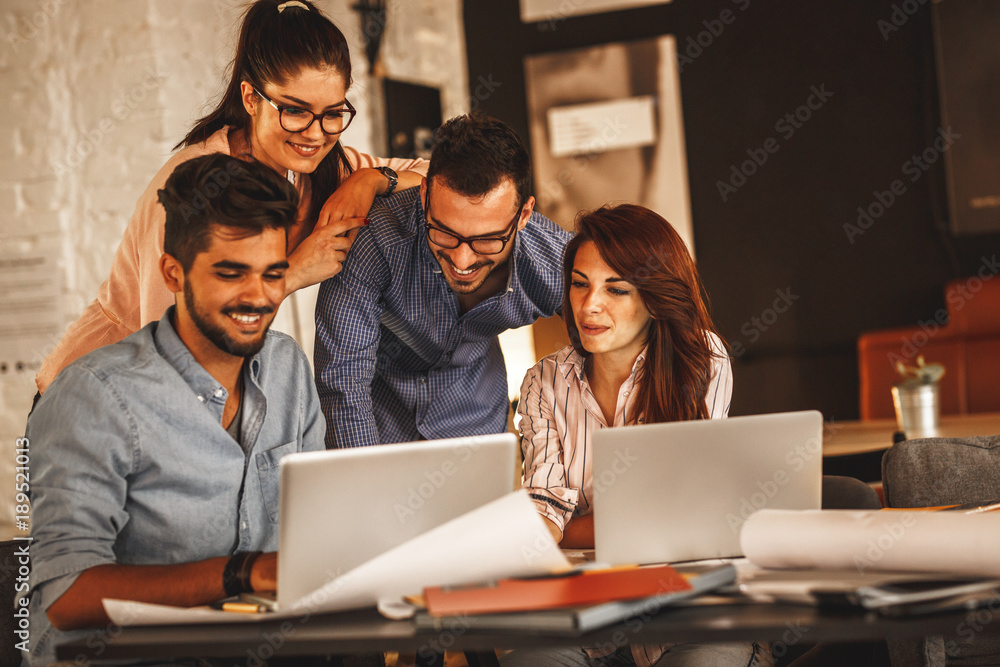 Group of casual concept designers working on new project .They using laptop and discuss about concept.Solving problems . Group of casual concept designers working on new project .They using laptop and discuss about concept.Solving problems .