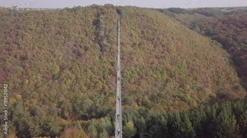 Aerial view of people walking on Suspension footbridge Geierlay (Hangeseilbrucke Geierlay), Germany. Original untouched LOG format. photo