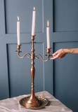 three candles in a candelabra on a table