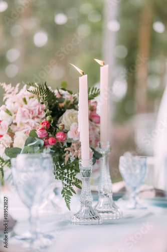  decor on the table with cutlery and flowers and candles with fire